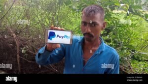 persona usando telefono con logo paypal visible