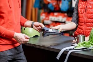persona usando una tarjeta en tienda deportiva